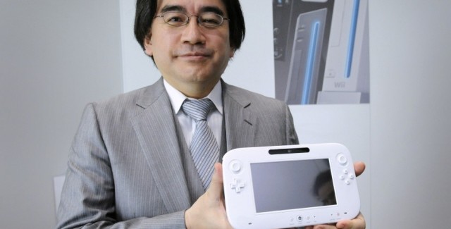 Satoru Iwata holding his baby, the Wii U Controller