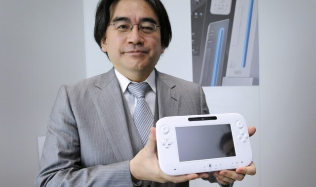 Satoru Iwata holding his baby, the Wii U Controller